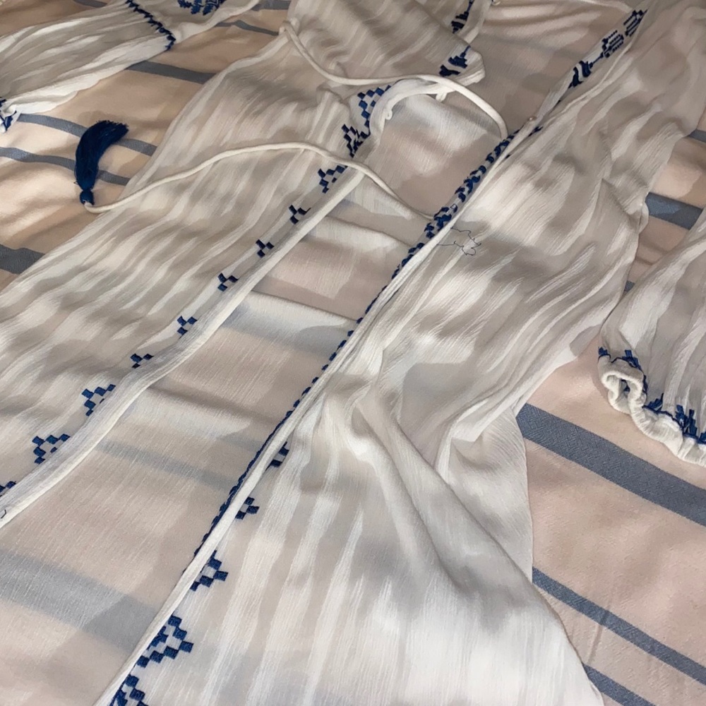 White beach cover up with blue stitched pattern